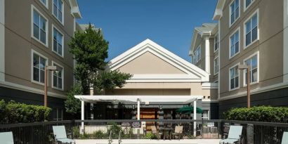Outdoor pool with sun loungers at Homewood Suites By Hilton Austin NW Near The Domain.