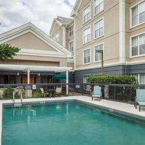 Outdoor pool with loungers at Homewood Suites By Hilton Austin NW Near The Domain.