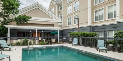 Outdoor pool with loungers at Homewood Suites By Hilton Austin NW Near The Domain.