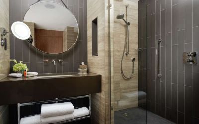Guest bathroom with shower at Hilton London Bankside. 