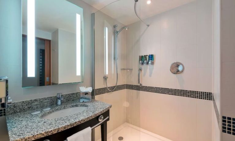 Guest bathroom with shower at Hampton By Hilton London Luton Airport.
