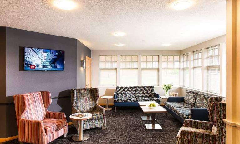 Lobby and coworking lounge at Leonardo Inn Aberdeen Airport.
