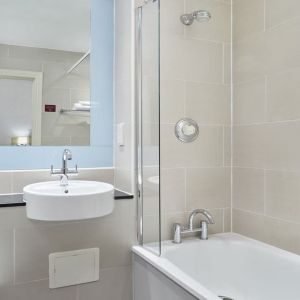 Guest bathroom with shower and tub at Leonardo Hotel Edinburgh City.