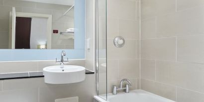 Guest bathroom with shower and tub at Leonardo Hotel Edinburgh City.