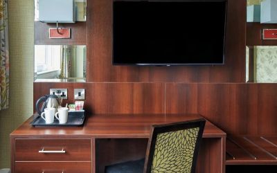 Day use room amenities like TV and coffee maker at Leonardo Inn Glasgow West End.