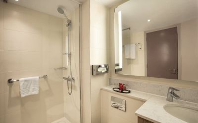 Guest bathroom with shower at Leonardo Hotel London Heathrow Airport.