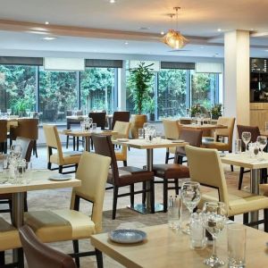 Dining area perfect for coworking at Leonardo Hotel London Heathrow Airport.