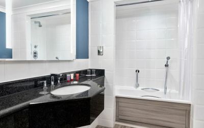 Guest bathroom with shower and tub at Leonardo Hotel Southampton Grand Harbour.