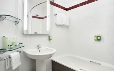 Guest bathroom with shower and tub at Leonardo Hotel Liverpool.