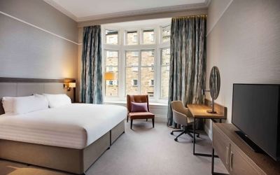 King bedroom with large window at Hilton Edinburgh Carlton.