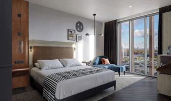 Bright king bedroom with view at The Gantry London, Curio Collection By Hilton.