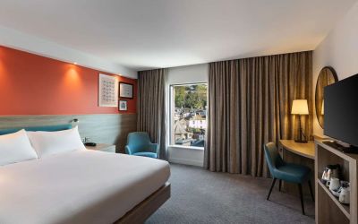 Luxurious king suite with TV and work desk at Hampton By Hilton Torquay.