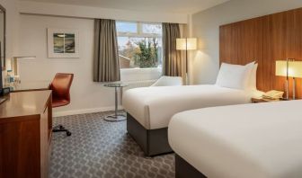 Day use room with double bed, work desk and TV at Hilton London Watford.