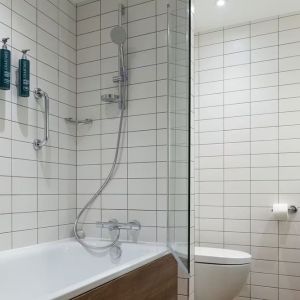 Guest bathroom with shower and tub at Hilton Garden Inn Stoke On Trent.