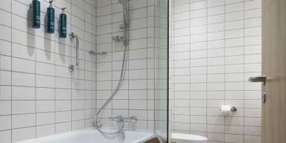 Guest bathroom with shower and tub at Hilton Garden Inn Stoke On Trent.