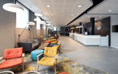 Spacious hotel lobby with lounge area, perfect for co-working at the Hampton by Hilton London Docklands.