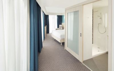 Bright day use room with TV, sofa and private bathroom at the Hampton by Hilton London Docklands.