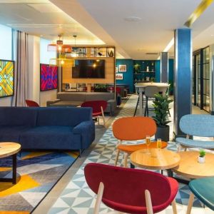 Lobby and coworking lounge at Hampton By Hilton London Park Royal.