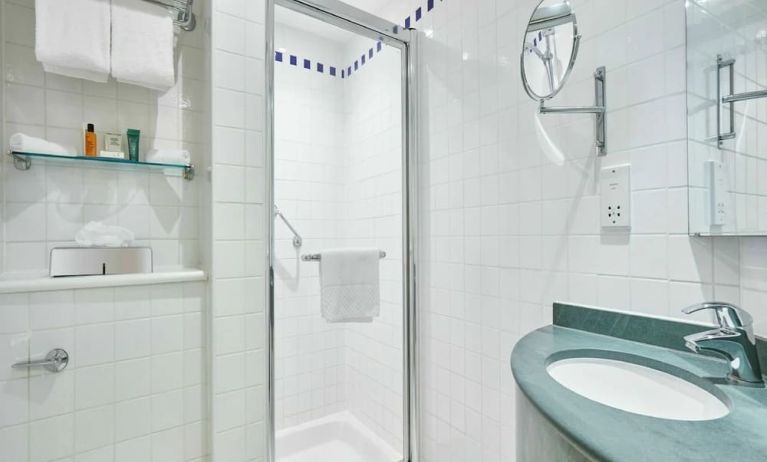Guest bathroom with shower and toiletries at the Hilton Garden Inn Birmingham Brindleyplace.