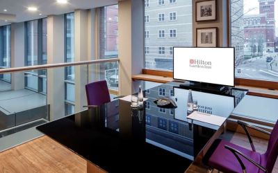 Meeting room with TV and large windows at the Hilton Garden Inn Birmingham Brindleyplace.