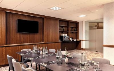Professional meeting room with TV screen and coffee maker at the Hilton Birmingham Metropole.