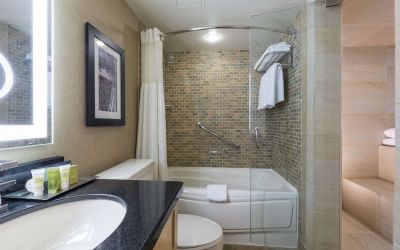 Guest bathroom with tub, sauna and toiletries at Hilton Whistler Resort & Spa.