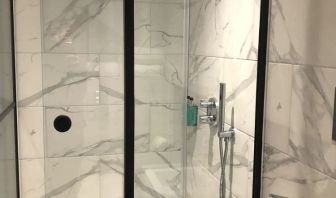 Guest bathroom with shower at Euston Square Hotel.