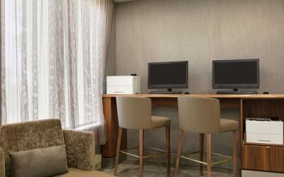 Business center with computers, printers and comfortable seating at the Embassy Suites by Hilton Montreal Airport.