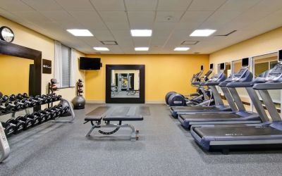 Fully equipped fitness center with treadmills and weights at the Hampton Inn by Hilton Toronto Airport Corporate Centre.