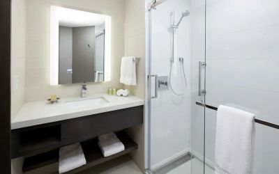 Private guest bathroom with shower and free toiletries at DoubleTree By Hilton Montreal.