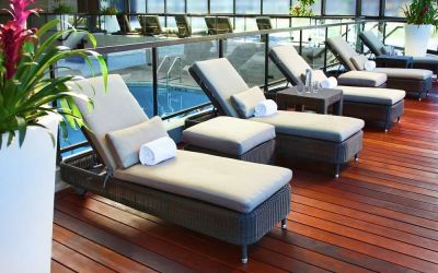 Relaxing indoor pool with lounge chairs at DoubleTree By Hilton Montreal.