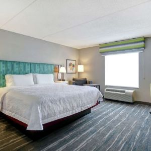 Bright day use room with king bed, work desk and private bathroom at the  Hampton Inn & Suites By Hilton Guelph.