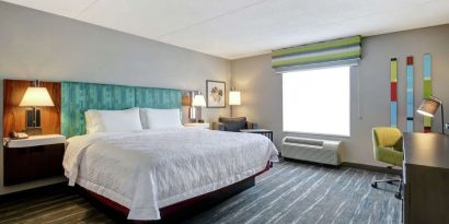 Bright day use room with king bed, work desk and private bathroom at the  Hampton Inn & Suites By Hilton Guelph.
