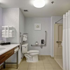Private guest bathroom with shower and free toiletries at the  Hampton Inn & Suites By Hilton Guelph.