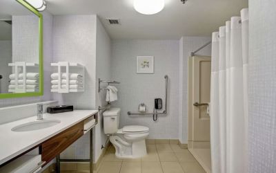 Private guest bathroom with shower and free toiletries at the  Hampton Inn & Suites By Hilton Guelph.