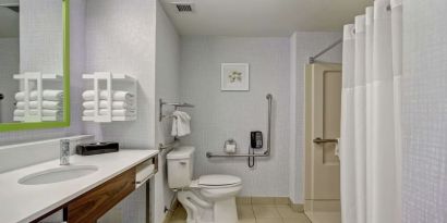 Private guest bathroom with shower and free toiletries at the  Hampton Inn & Suites By Hilton Guelph.