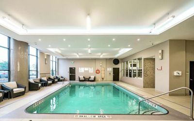 Relaxing indoor pool with lounge chairs at DoubleTree By Hilton Kitchener.