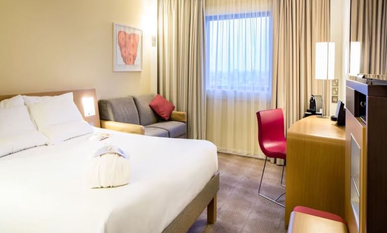 Day use room with work desk and sofa at Novotel London Paddington.
