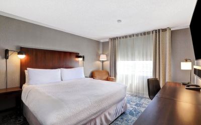 Day use room with TV, sofa, work desk and private bathroom at Four Points By Sheraton Toronto Mississauga.