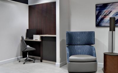 Business center with computer, printer and ergonomic chair at Courtyard By Marriott Edmonton Downtown.