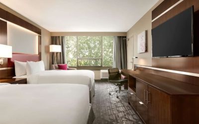 Day use twin room with large windows, TV, sofa, work desk and private bathroom at DoubleTree By Hilton Hotel Toronto Airport West.