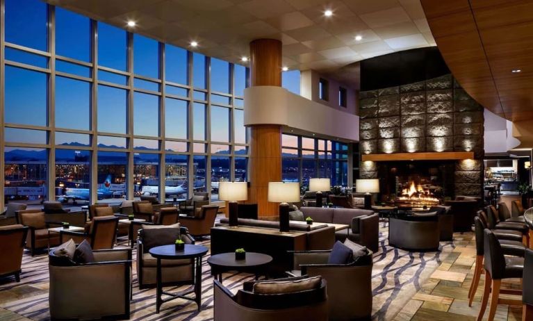 Hotel bar lounge area with fireplace at Fairmont Vancouver Airport - YVR Terminal Hotel.