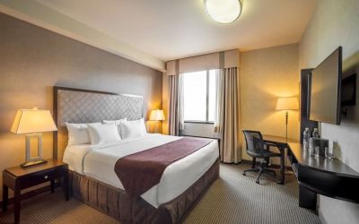 Standard day use room with TV, work desk and private bathroom at Acclaim Hotel Calgary Airport.
