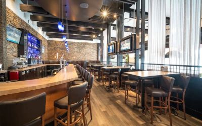Hotel bar with lounge seating at Acclaim Hotel Calgary Airport.