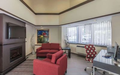 Hotel lobby with fireplace and worskpace with computer and printer at Comfort Inn Corner Brook.
