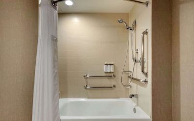 Guest bathroom with shower and tub at Cambria Suites Denver Airport.