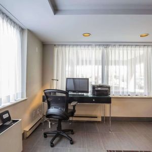 Business center with computer, printer and ergonomic chair at Comfort Inn Pickering.