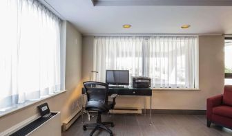 Business center with computer, printer and ergonomic chair at Comfort Inn Pickering.