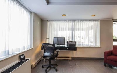 Business center with computer, printer and ergonomic chair at Comfort Inn Pickering.