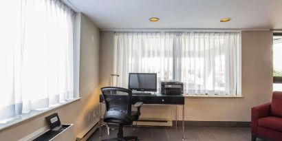 Business center with computer, printer and ergonomic chair at Comfort Inn Pickering.
